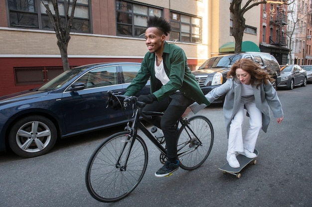A split image showing someone riding a bicycle on one side and someone using public transportation on the other, representing alternative ways to reduce transportation costs.