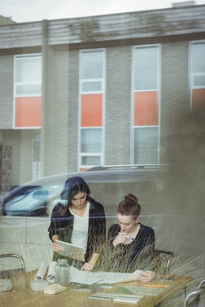 A family looking at a college campus, with a subtle overlay of financial growth charts representing the benefits of using a 529 plan.