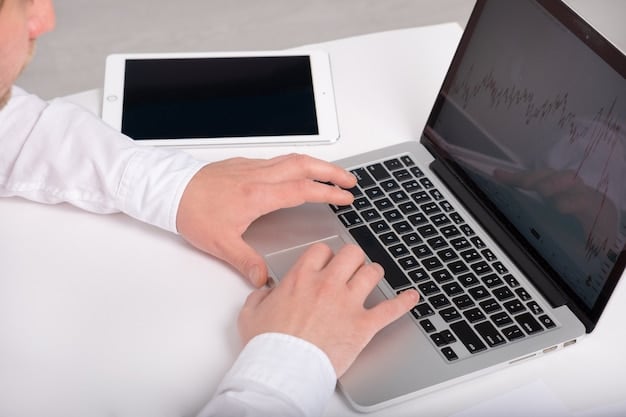 A close-up of an investor's hands typing on a laptop, with charts and graphs visible in the background, illustrating the process of analyzing investment portfolios for tax loss harvesting opportunities.