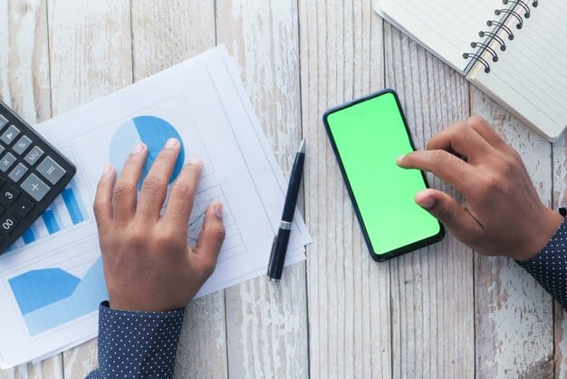 A person using a financial planning app on a smartphone, with charts and graphs displaying income, expenses, and estimated tax liabilities. The image conveys the use of technology to manage finances and stay on top of tax obligations.