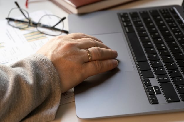 A close-up shot of hands typing on a laptop, symbolizing the research and application process for securing grants.