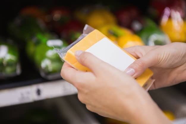 A close-up of a hand holding a SNAP card, with blurred grocery store shelves in the background. The image should convey the importance of SNAP benefits for purchasing essential food items.