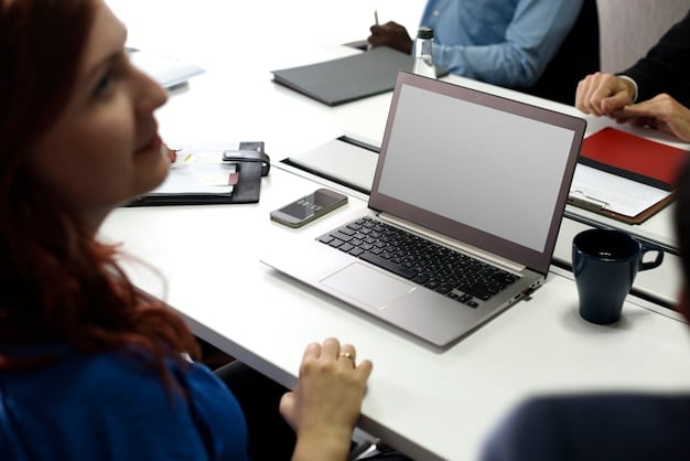 A close-up of an official government website on a laptop screen, highlighting sections about small business assistance programs and application deadlines. The background is a modern office space.
