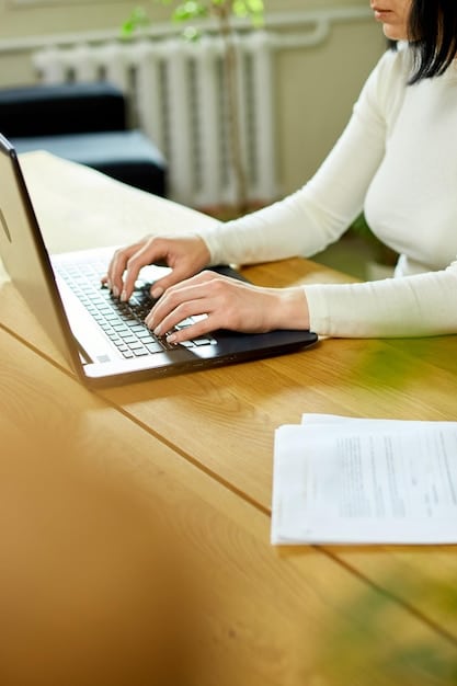 A close-up shot of hands typing on a laptop, with official forms and documents related to Social Security and disability benefits visible in the background. The focus is on the act of applying and seeking information about disability benefits.