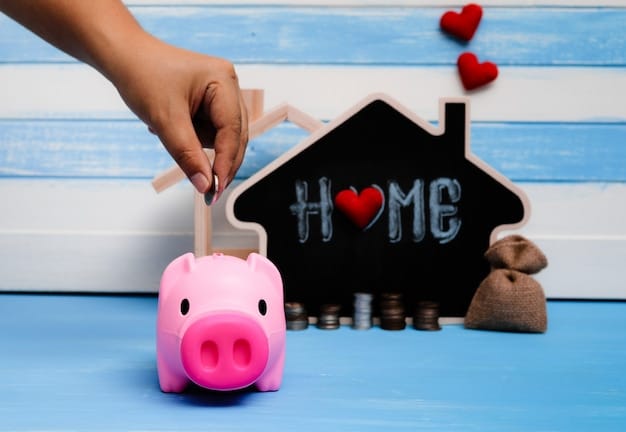 A close-up of a hand holding a house-shaped piggy bank, with coins falling into it. The background is blurred, showcasing financial documents and a calculator.
