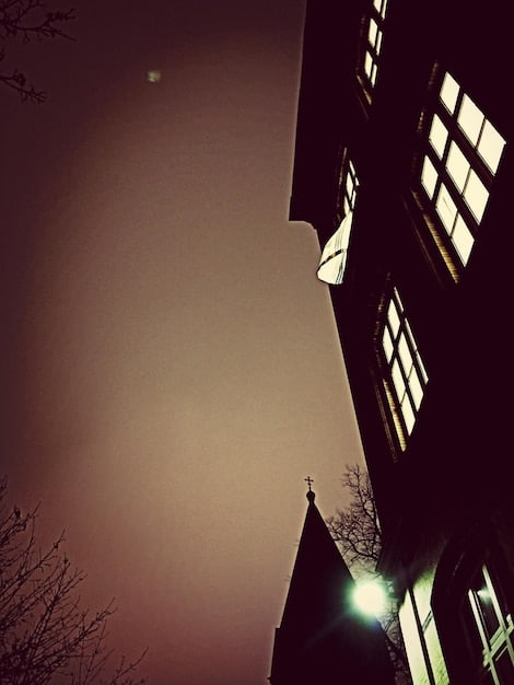A split image showing a warm, well-lit home on one side and a dark, cold home on the other, highlighting the impact of energy assistance.