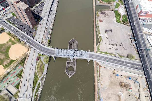 An aerial view of a newly constructed bridge spanning a wide river, connecting two urban areas, symbolizing improved transportation infrastructure.