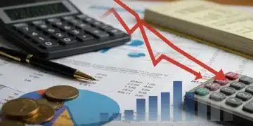 Financial documents, calculator, and a graph with a downward arrow symbolizing debt reduction and financial control.